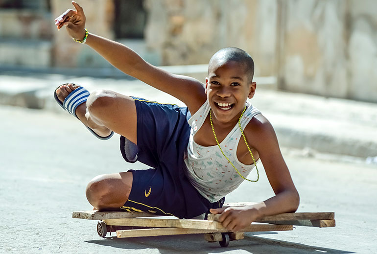 Cuban boy and homemade skateboard.