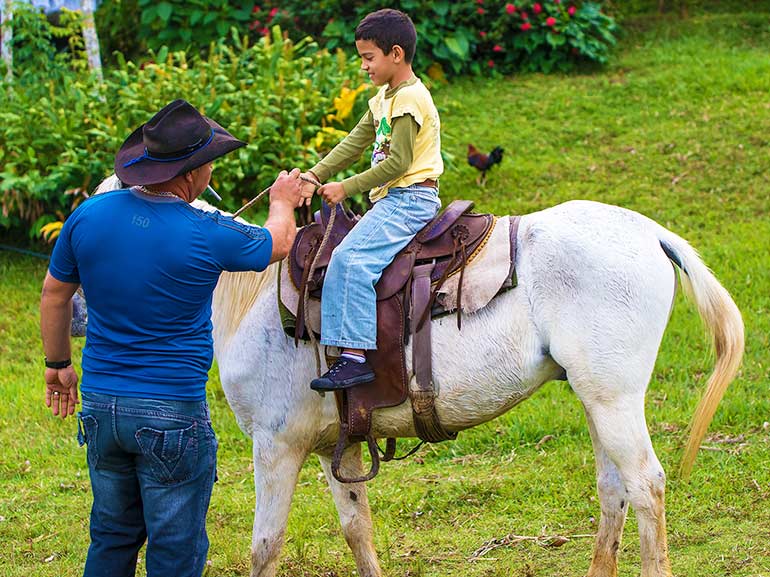 Cuban boy learns to ride a horse.