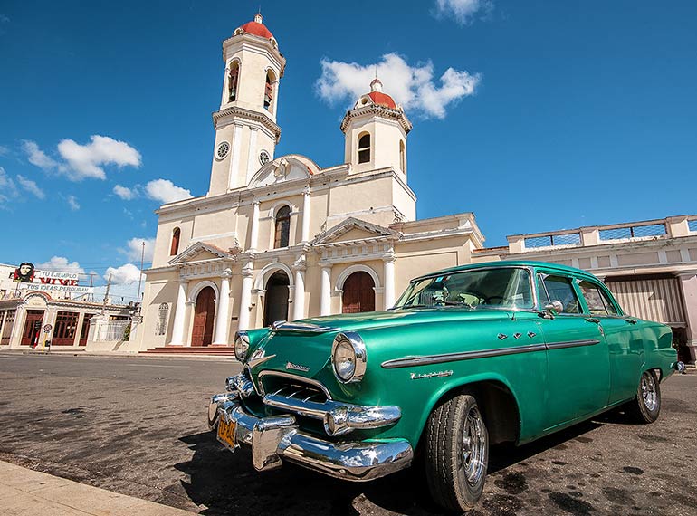 Old car and church in Cienfuegos, Cuba.