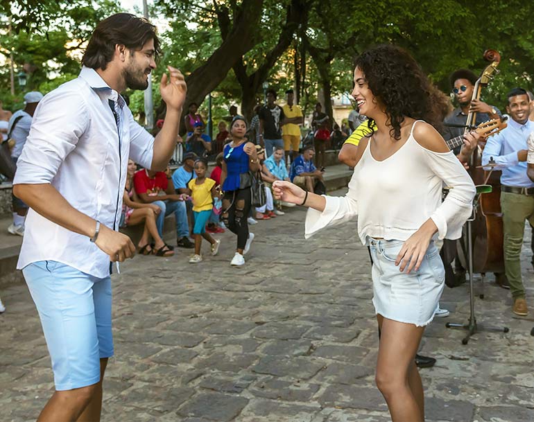 Couple dancing in Havana park.