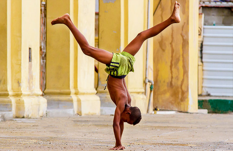 Cuban boy performs handstand.
