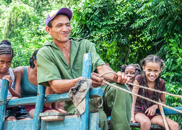 Cuba farm kids ride oxcart.