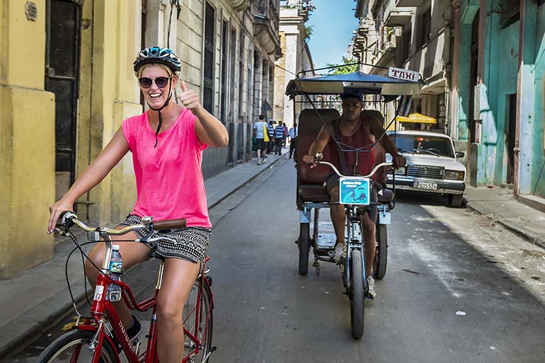 Woman biking in Old Havana.
